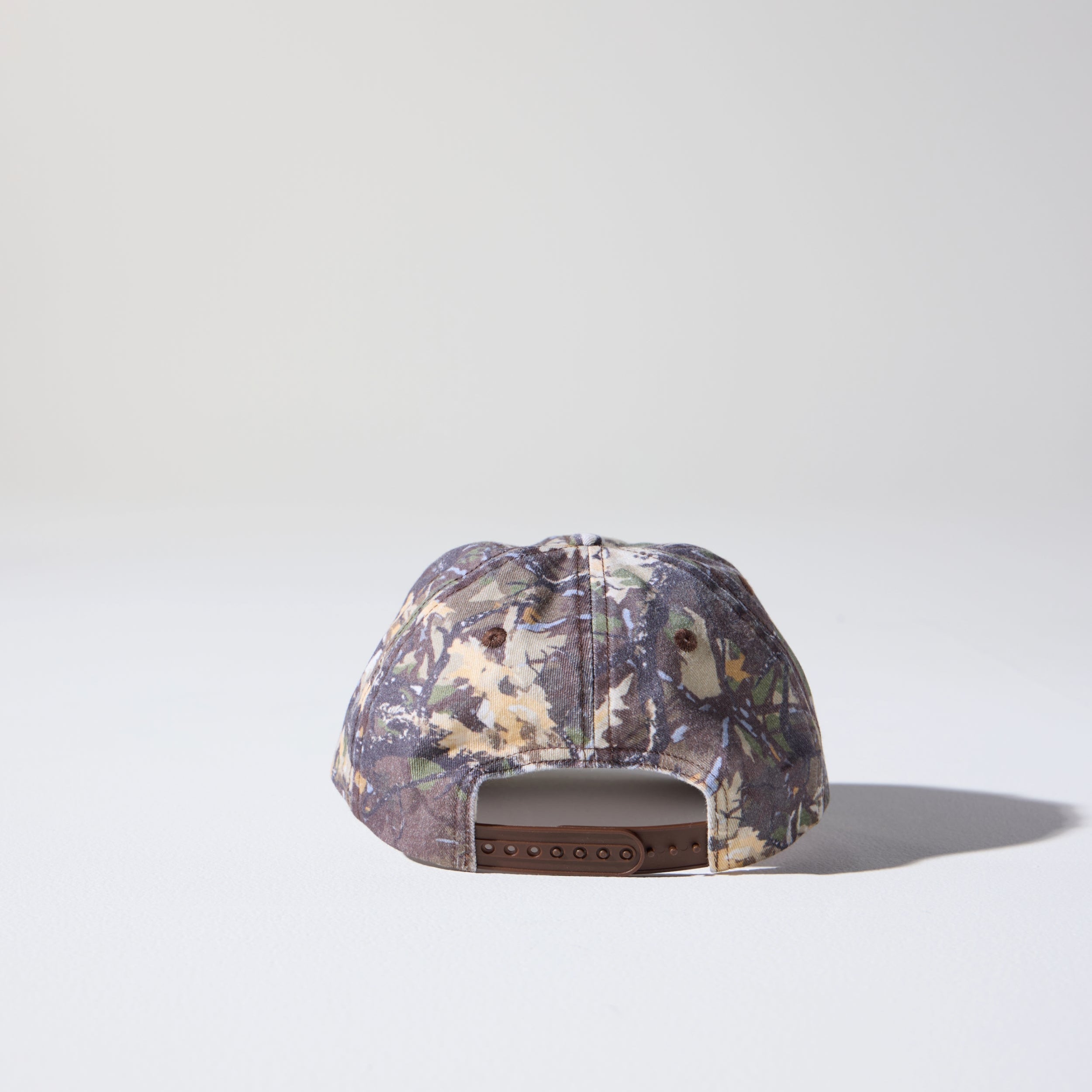 A camo tree pattern, 6-panel unstructured 'Dad' cap made of recycled cotton twill with snap back