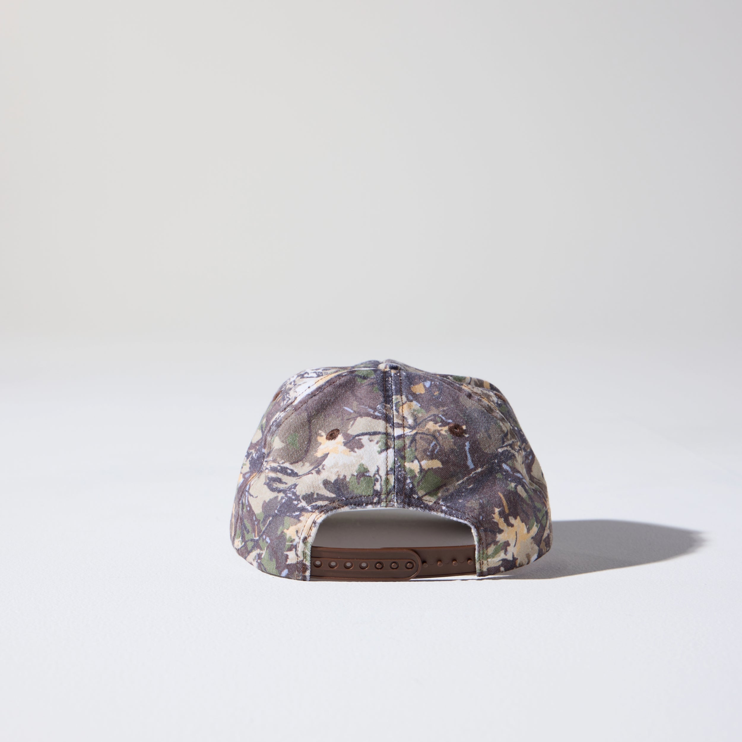 A deep fit camo tree pattern, 5 panel cap made of recycled cotton canvas with snap back, made for larger heads. Designed by House of Peaks.