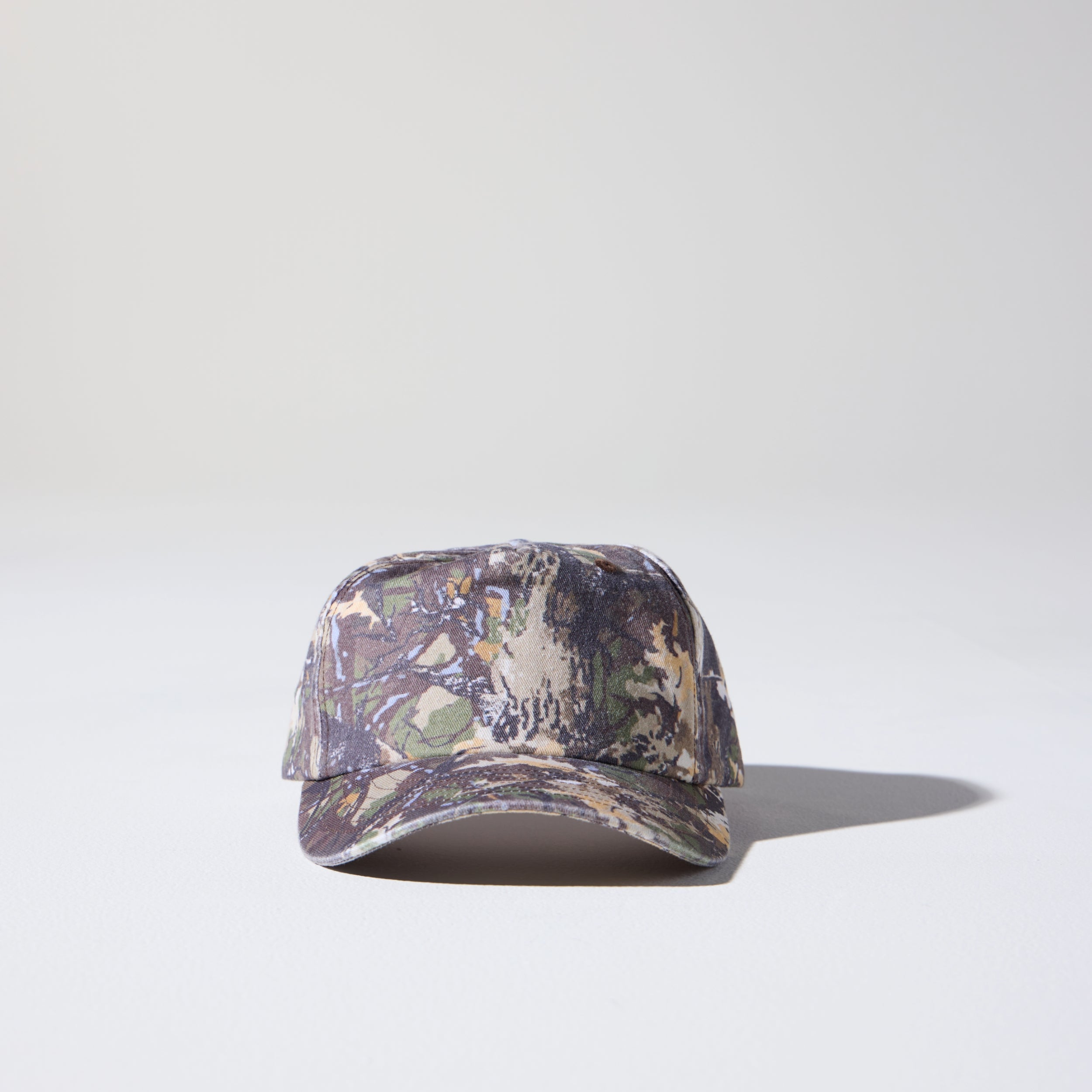 A deep fit camo tree pattern, 5 panel cap made of recycled cotton canvas with snap back, made for larger heads. Designed by House of Peaks.