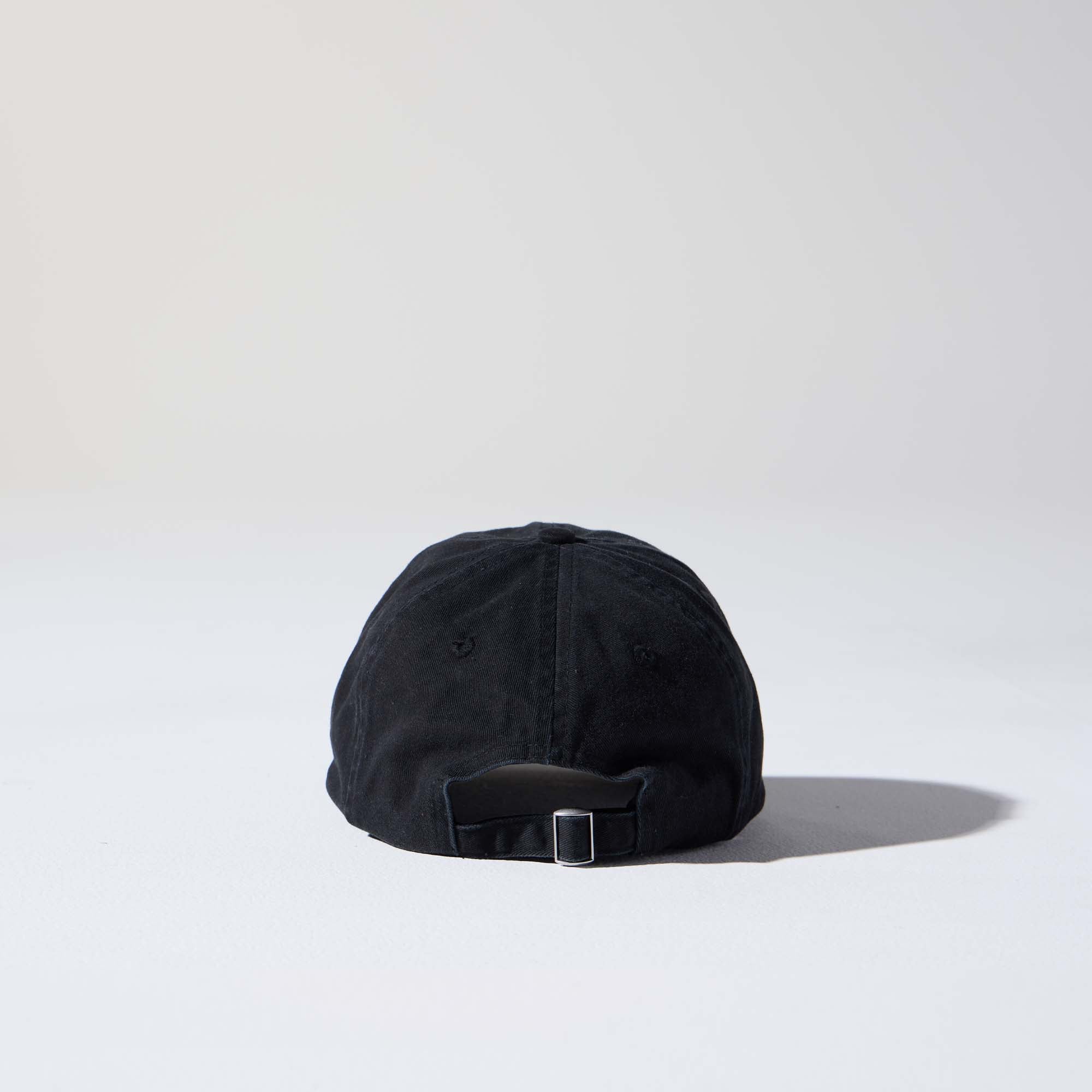 A black-coloured, 6-panel unstructured 'Dad' cap made of recycled cotton twill with an adjustable material buckle. Best Blank Hats by House of Peaks.