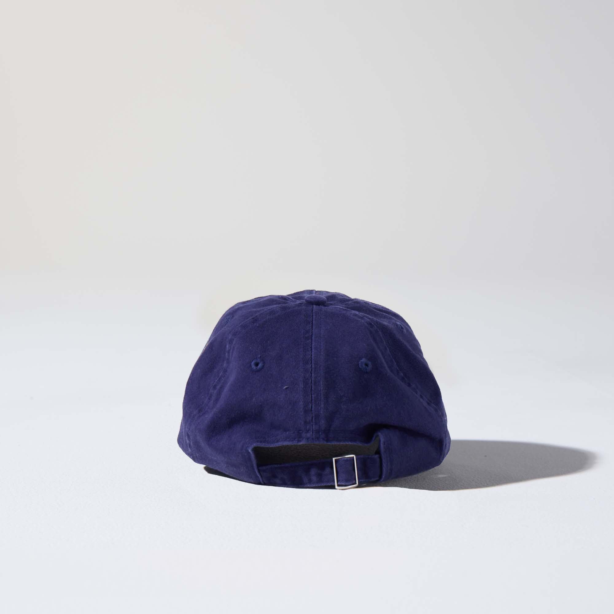 A navy-coloured, 6-panel unstructured 'Dad' cap made of recycled cotton twill with an adjustable material buckle. Best Blank Hats by House of Peaks.