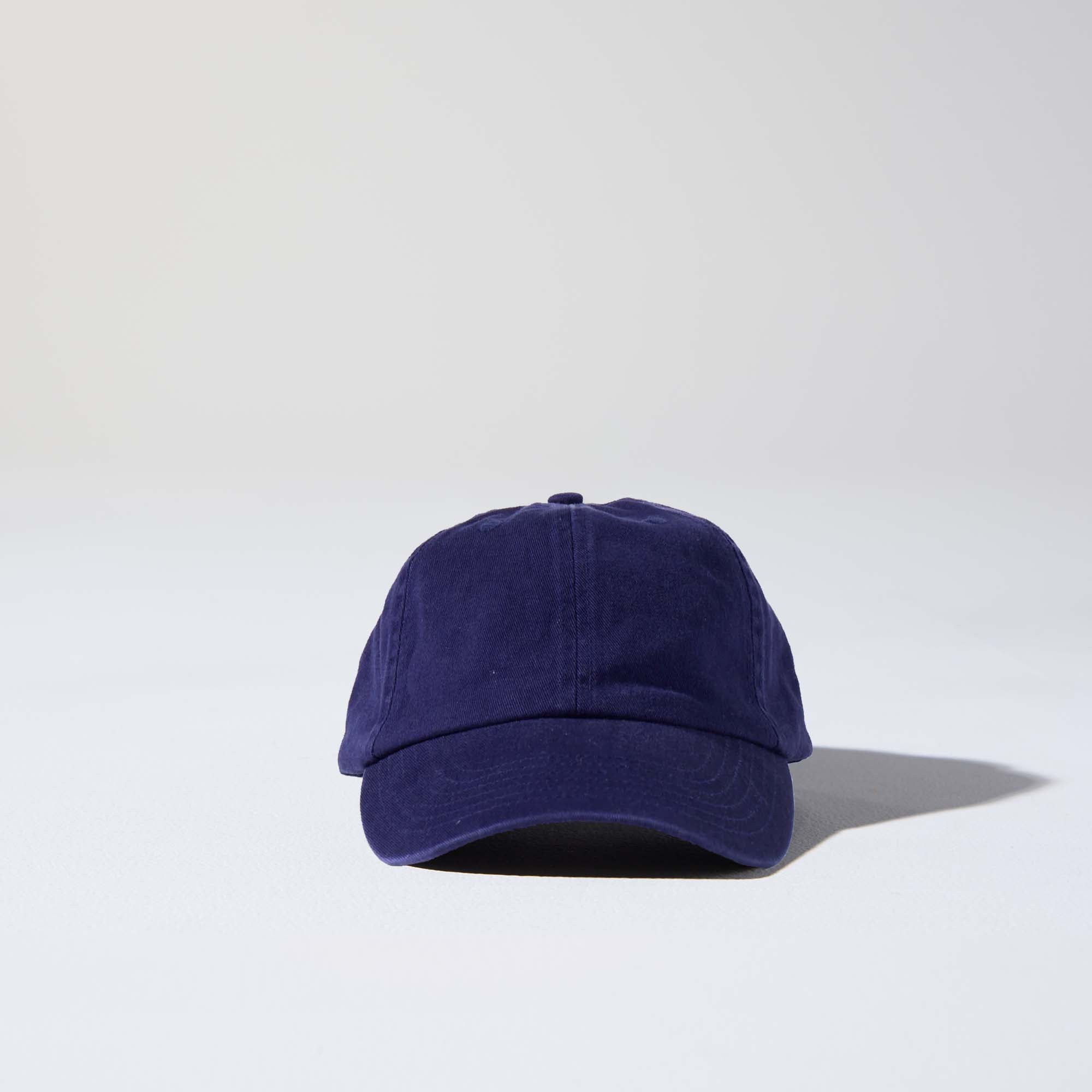 A navy-coloured, 6-panel unstructured 'Dad' cap made of recycled cotton twill with an adjustable material buckle. Best Blank Hats by House of Peaks.
