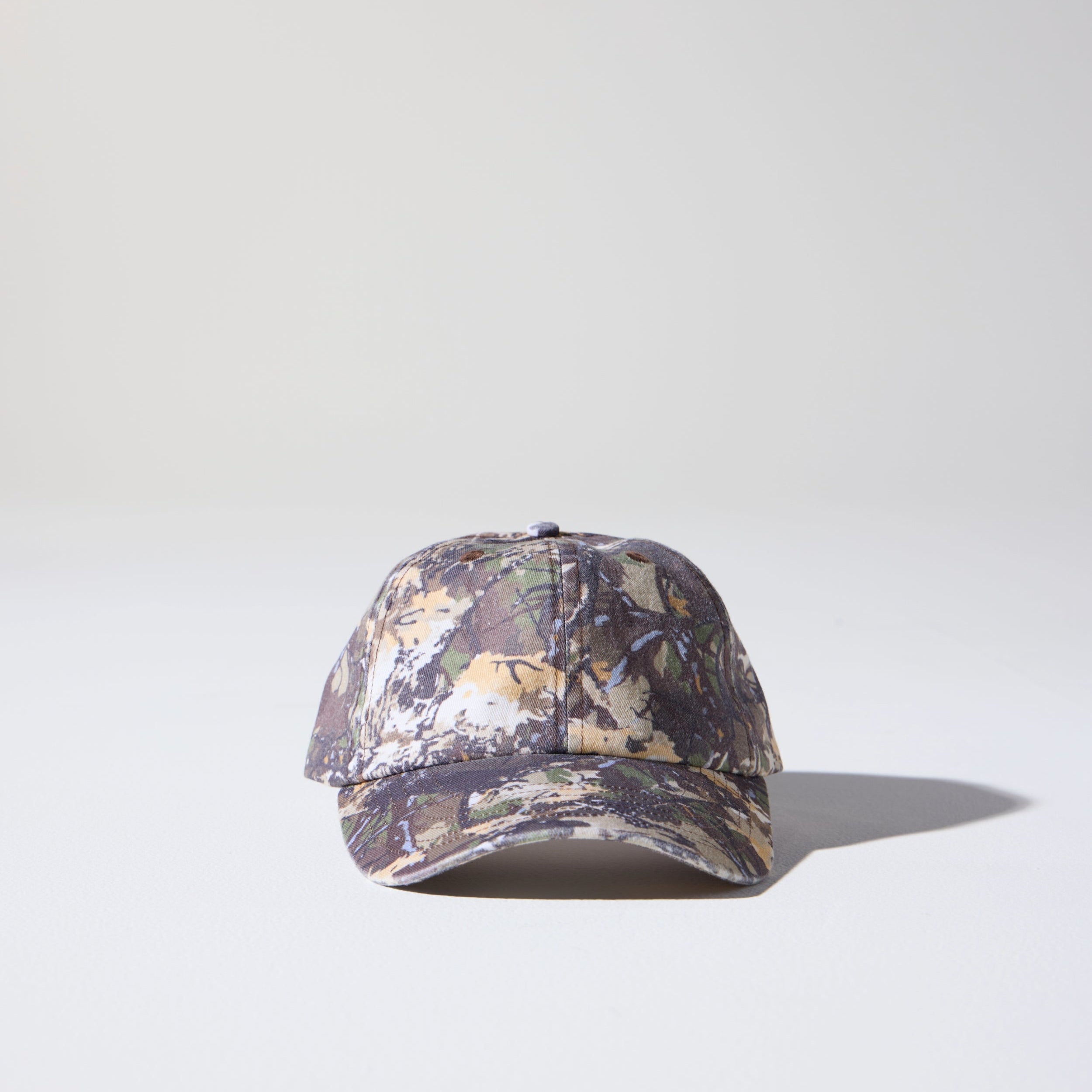 A camo tree pattern, 6-panel unstructured 'Dad' cap made of recycled cotton twill with snap back