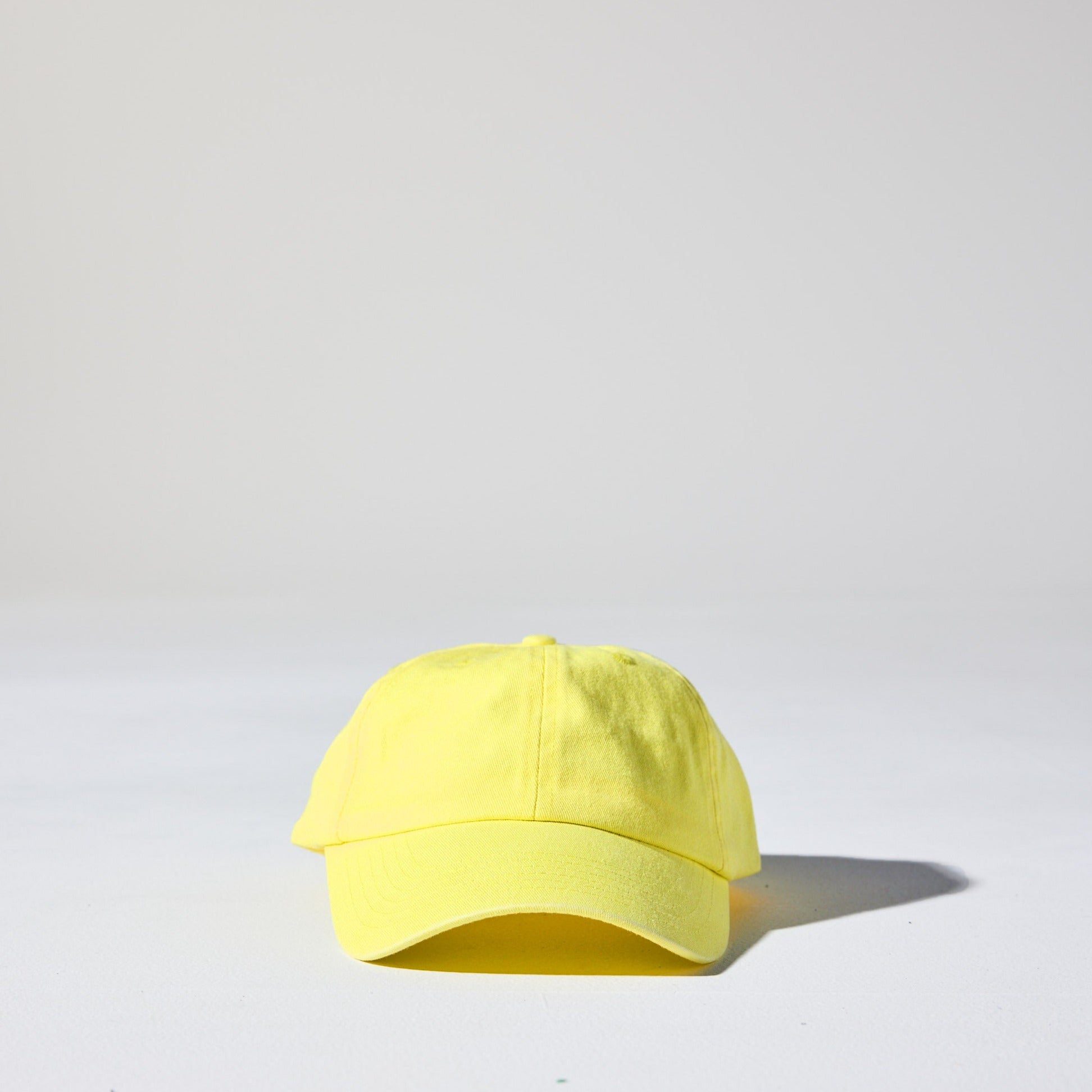 A acid yellow coloured, 6-panel unstructured 'Dad' baseball cap made of recycled cotton twill with snap back by House of Peaks.