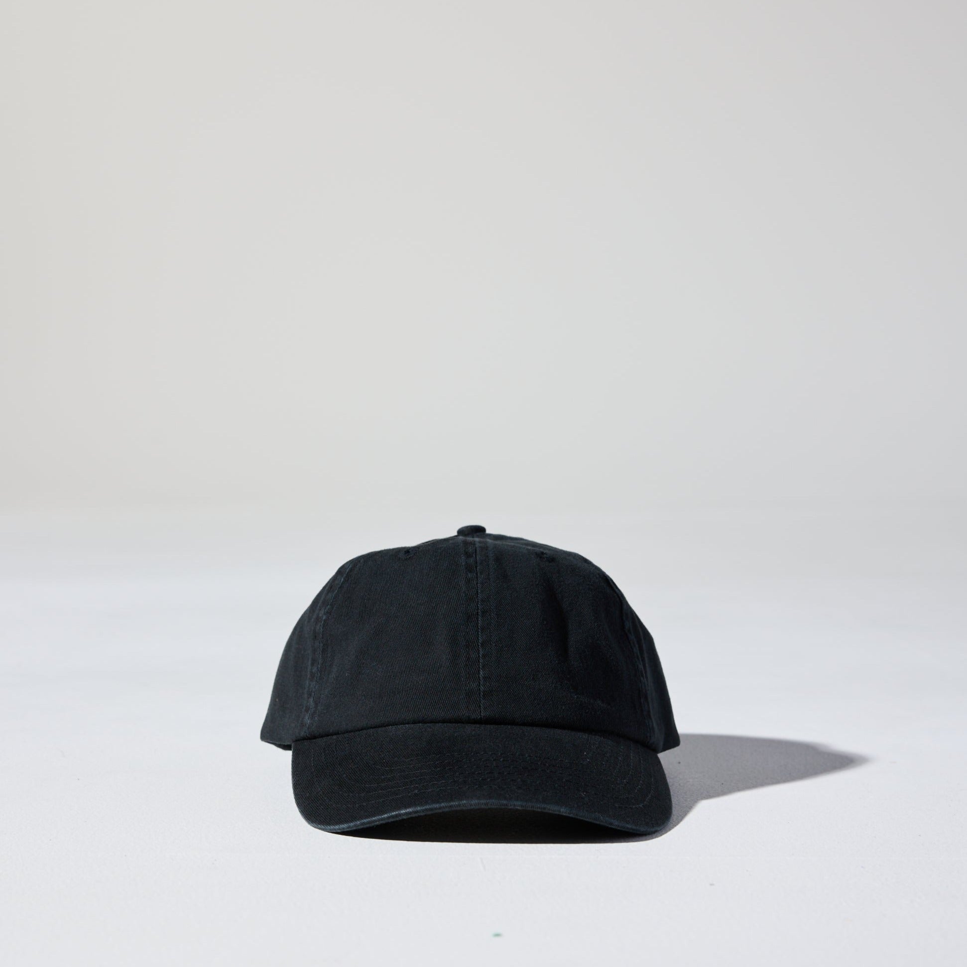 A black, 6-panel unstructured 'Dad' baseball cap made of recycled cotton twill with snap back by House of Peaks.