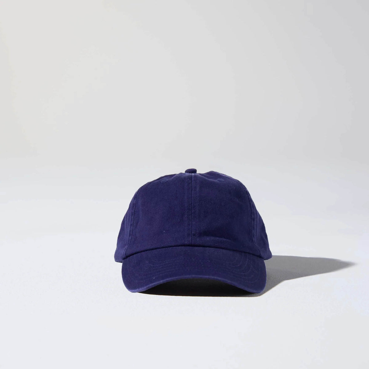 A navy blue coloured, 6-panel unstructured 'Dad' baseball cap made of recycled cotton twill with snap back by House of Peaks. Australian Hats
