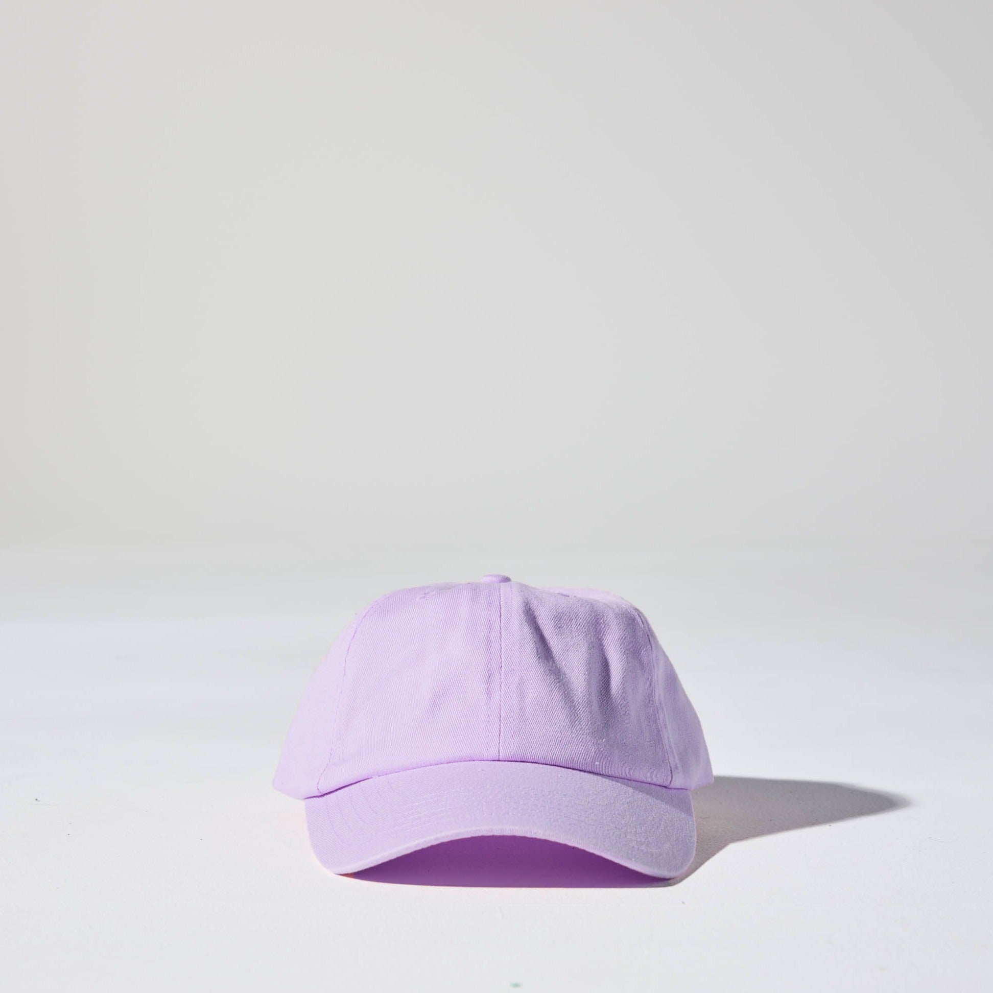 A pastel purple coloured, 6-panel unstructured 'Dad' baseball cap made of recycled cotton twill with snap back by House of Peaks.