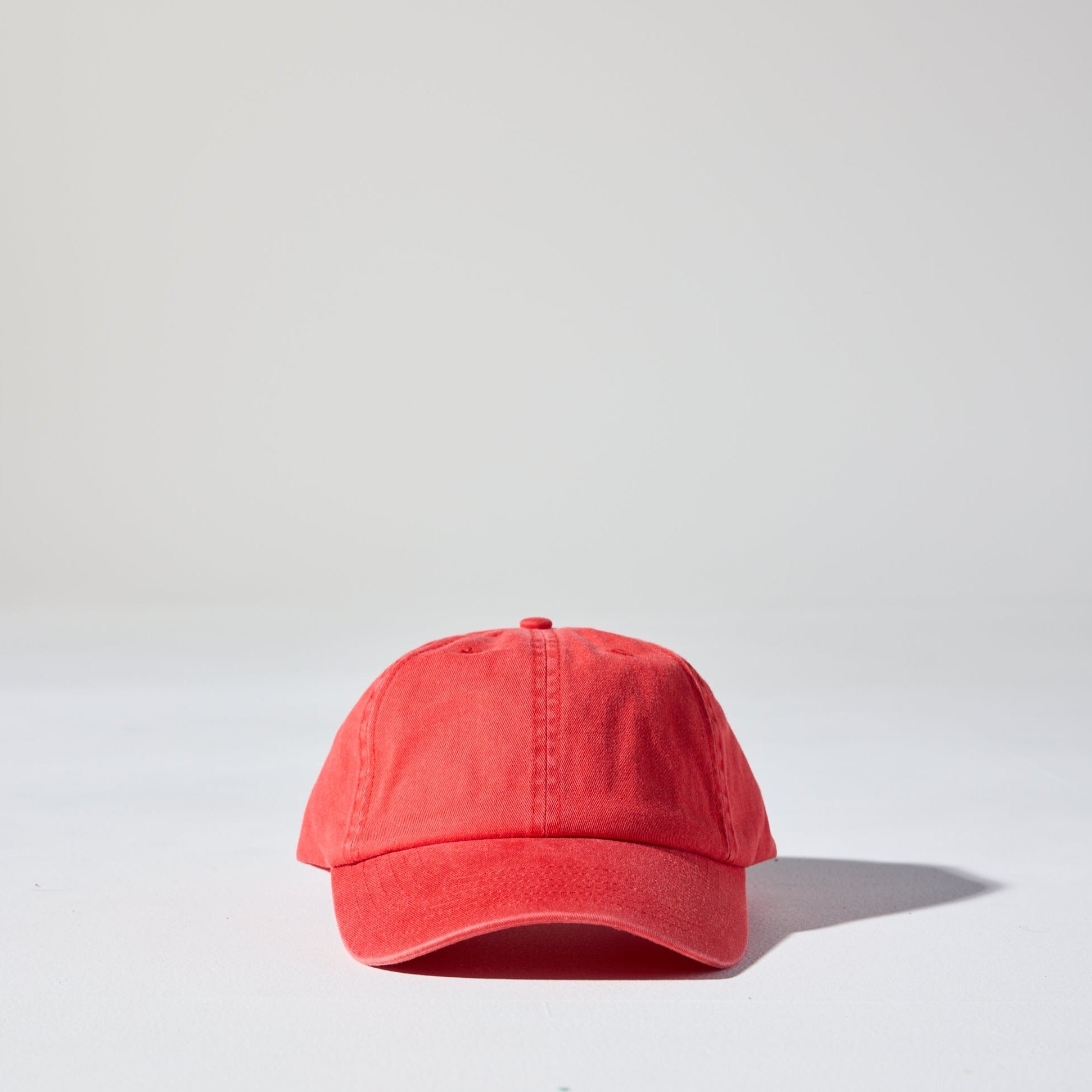 A bright red coloured, 6-panel unstructured 'Dad' baseball cap made of recycled cotton twill with snap back by House of Peaks.