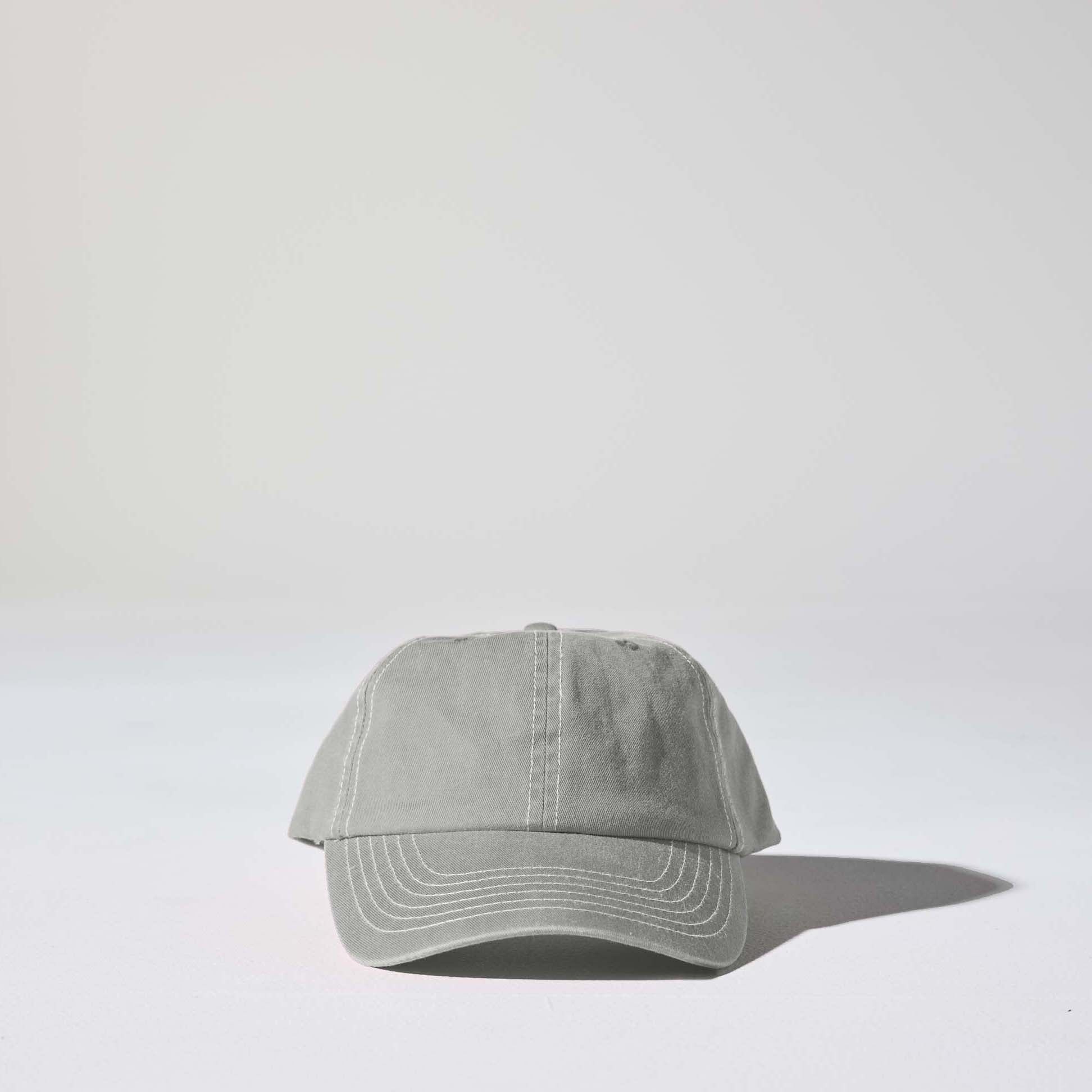 A light grey 6 panel 'Dad' cap with white contrast stitching and an adjustable plastic snapback adjustment. Best Blank Hats by House of Peaks.
