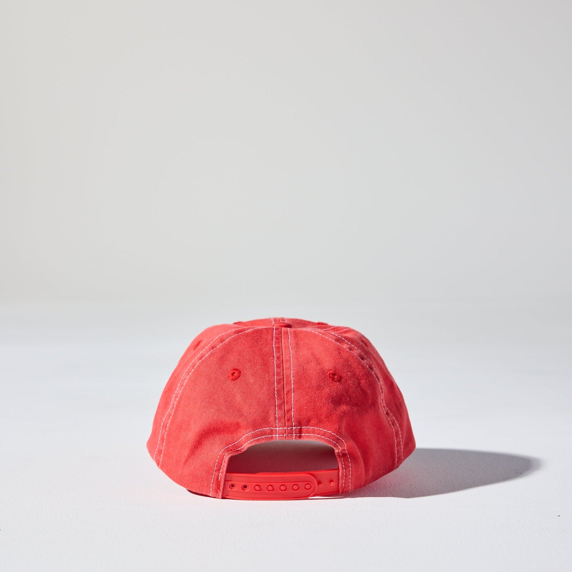 A red 6 panel 'Dad' cap with white contrast stitching and an adjustable plastic snapback adjustment. Best Blank Hats by House of Peaks.
