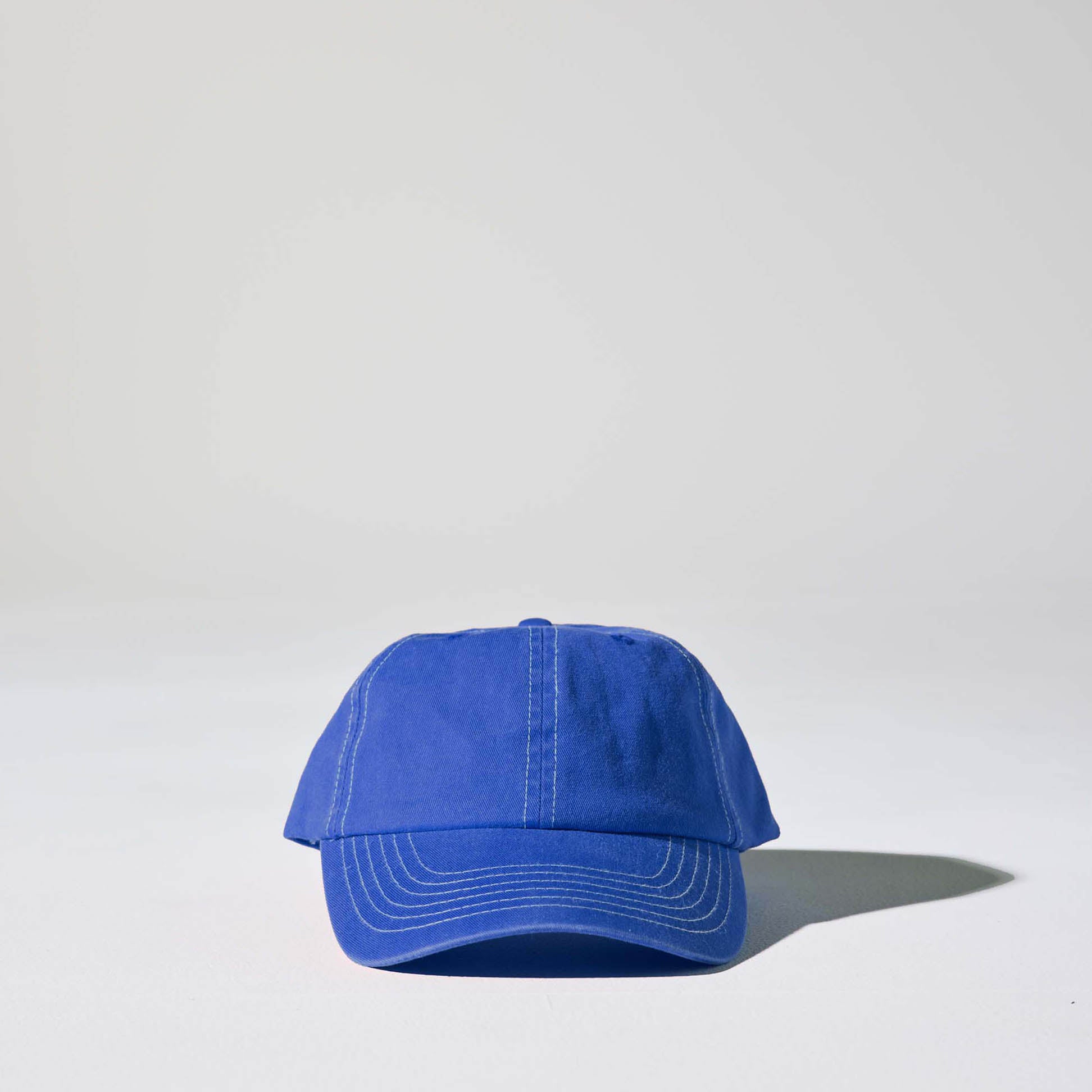 A royal blue 6 panel 'Dad' cap with white contrast stitching and an adjustable plastic snapback adjustment. Best Blank Hats by House of Peaks.