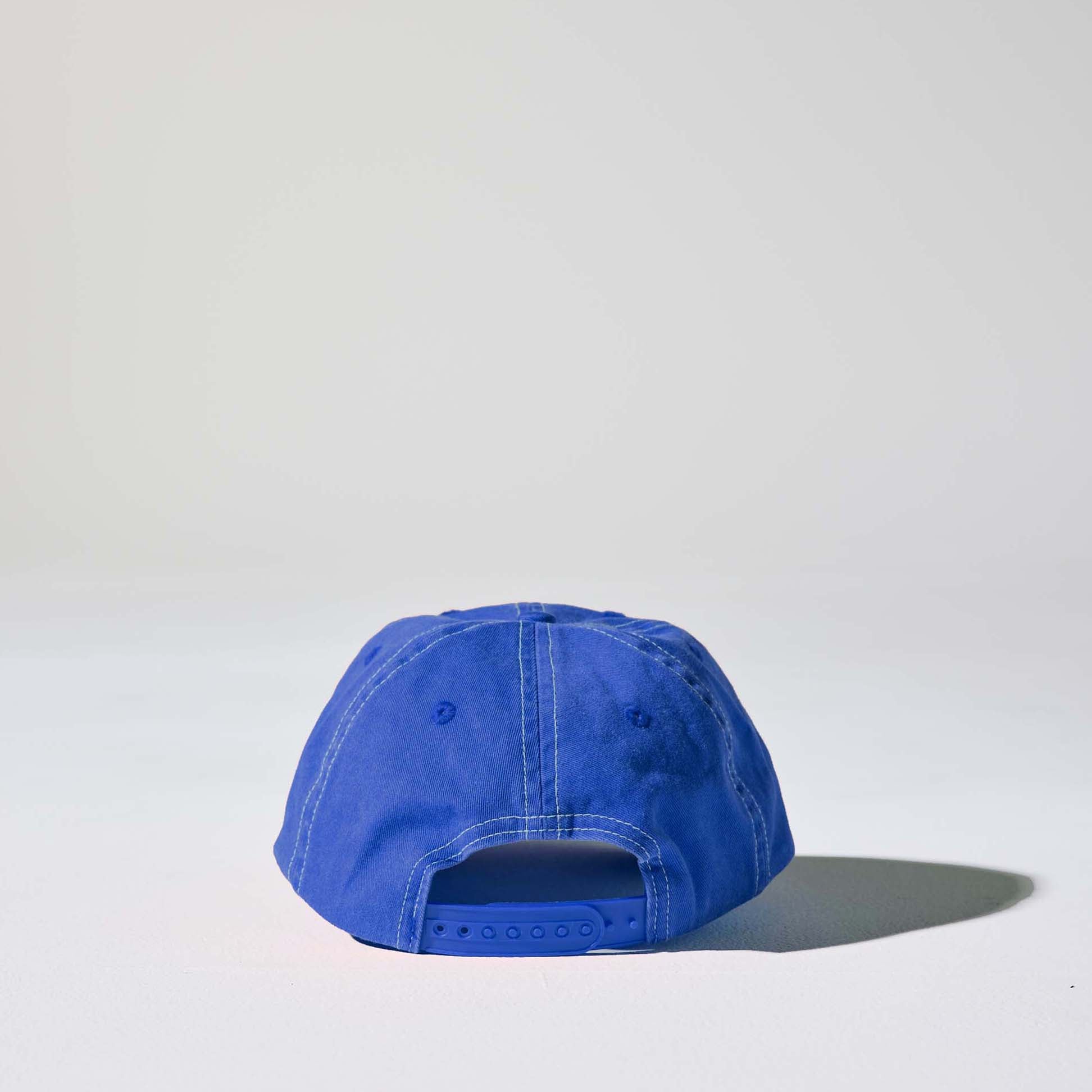 A royal blue 6 panel 'Dad' cap with white contrast stitching and an adjustable plastic snapback adjustment. Best Blank Hats by House of Peaks.