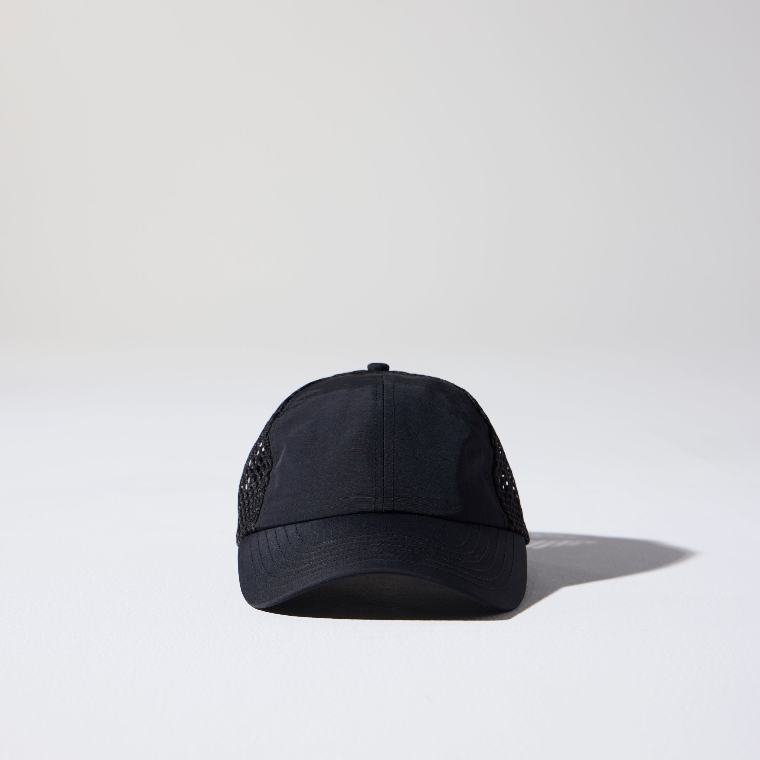 Friday Mesh Cap in Black by House of Peaks – recycled nylon running hat with breathable mesh and bungee cord.
