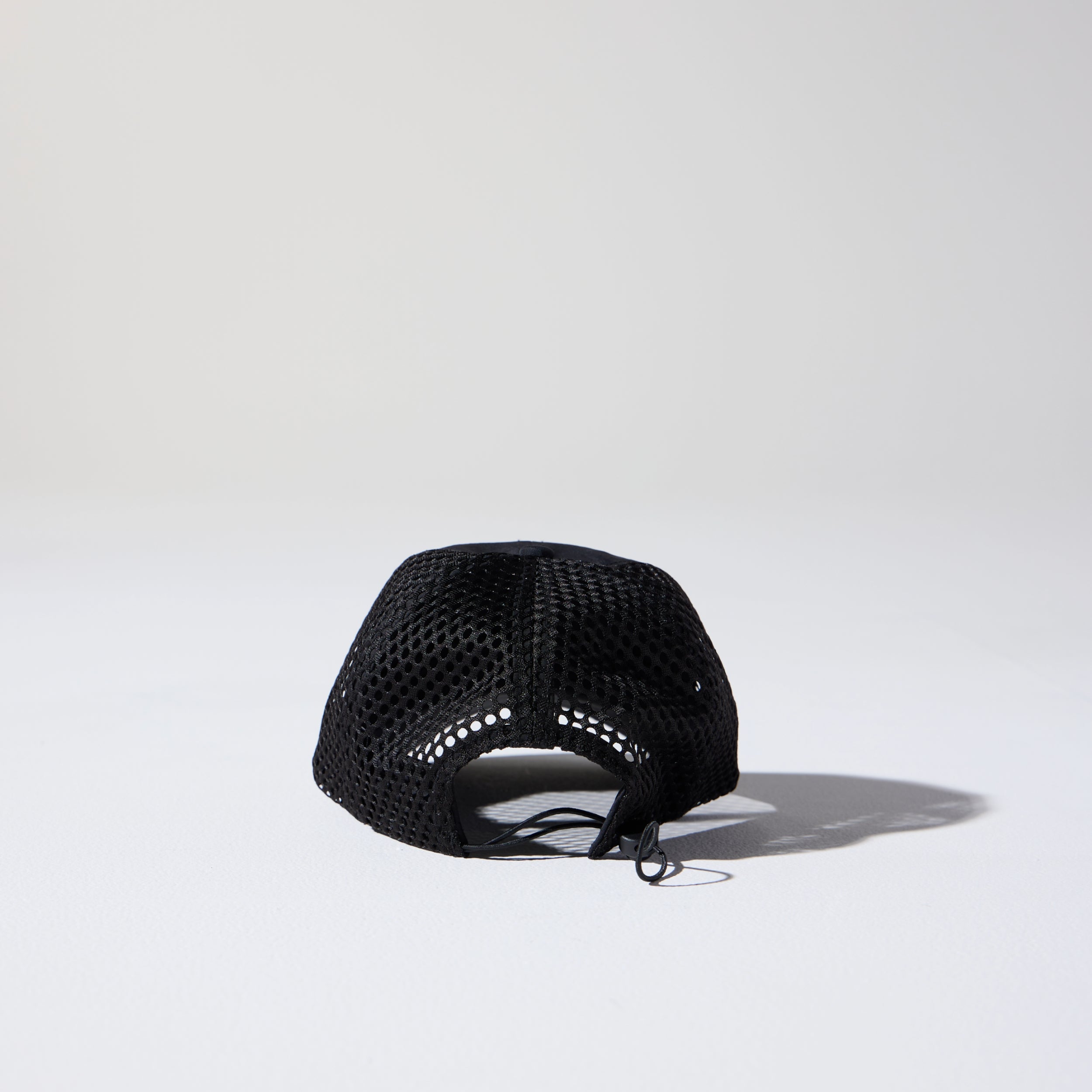 Back of Friday Mesh Cap in Black by House of Peaks – recycled nylon running hat with breathable mesh and bungee cord.