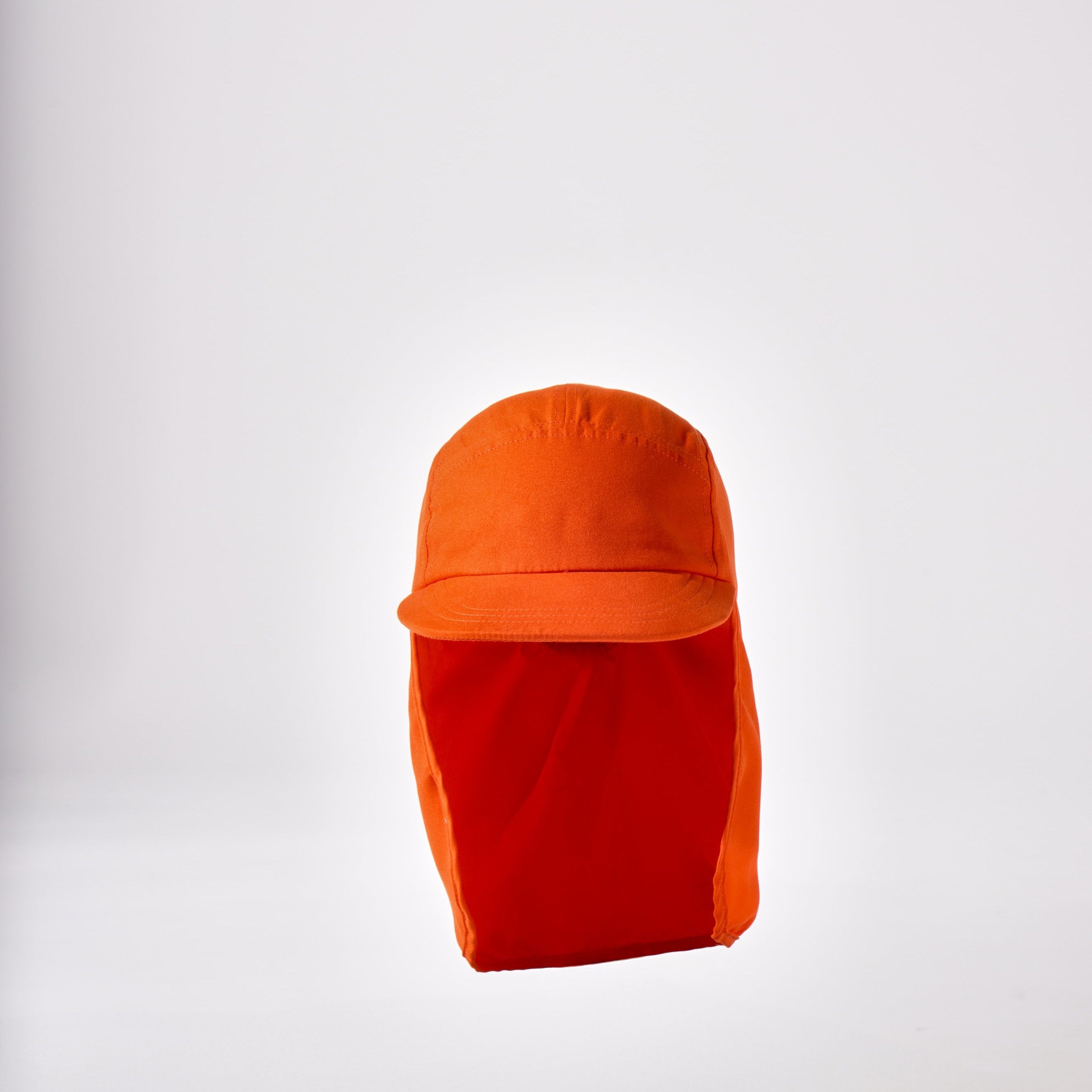 An orange holiday legionnaire sun protection cap by House of Peaks with neck flap and an adjustable bungee cord.
