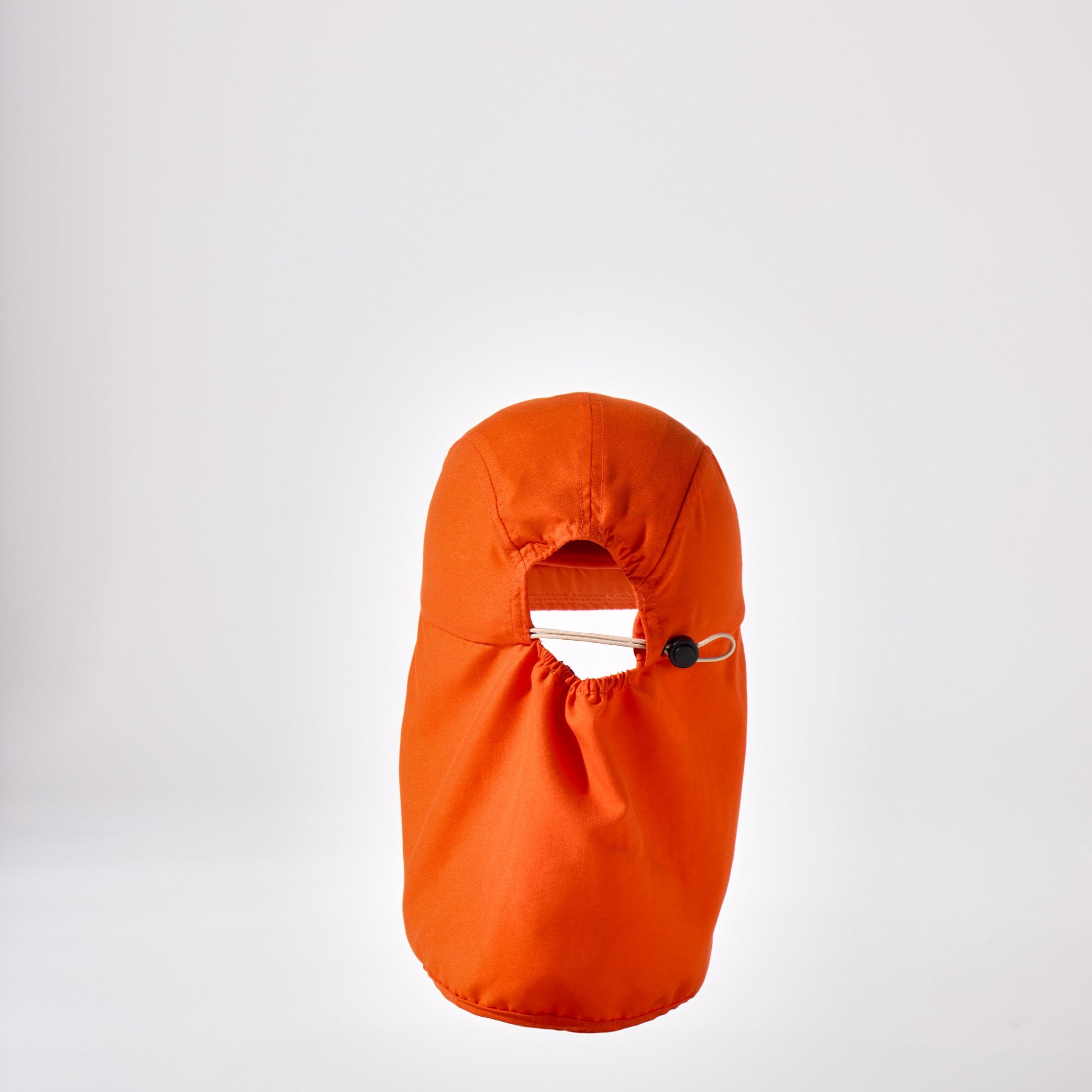 An orange holiday legionnaire sun protection cap by House of Peaks with neck flap and an adjustable bungee cord.