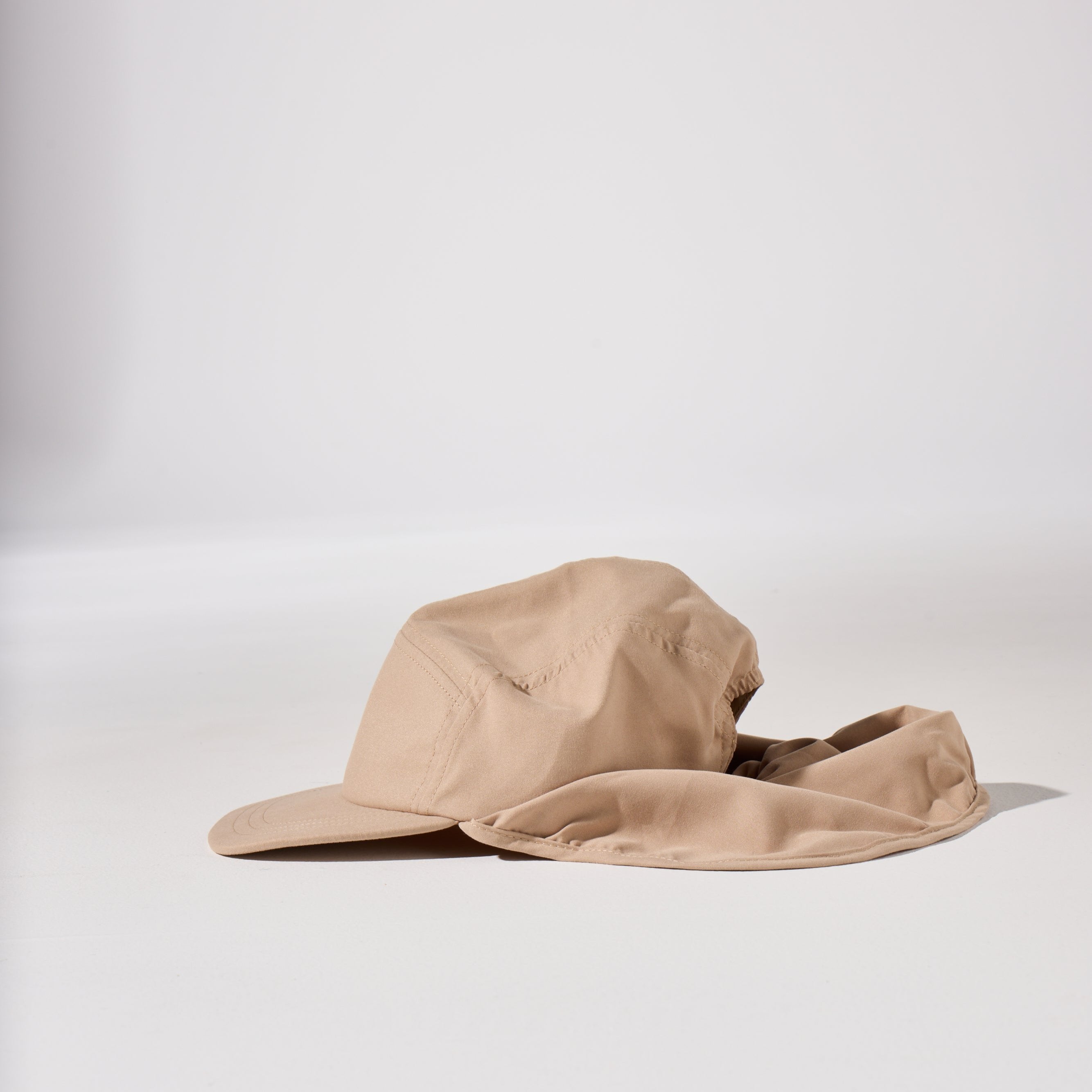 A tan, beige and brown holiday legionnaire sun protection cap by House of Peaks with neck flap and an adjustable bungee cord.