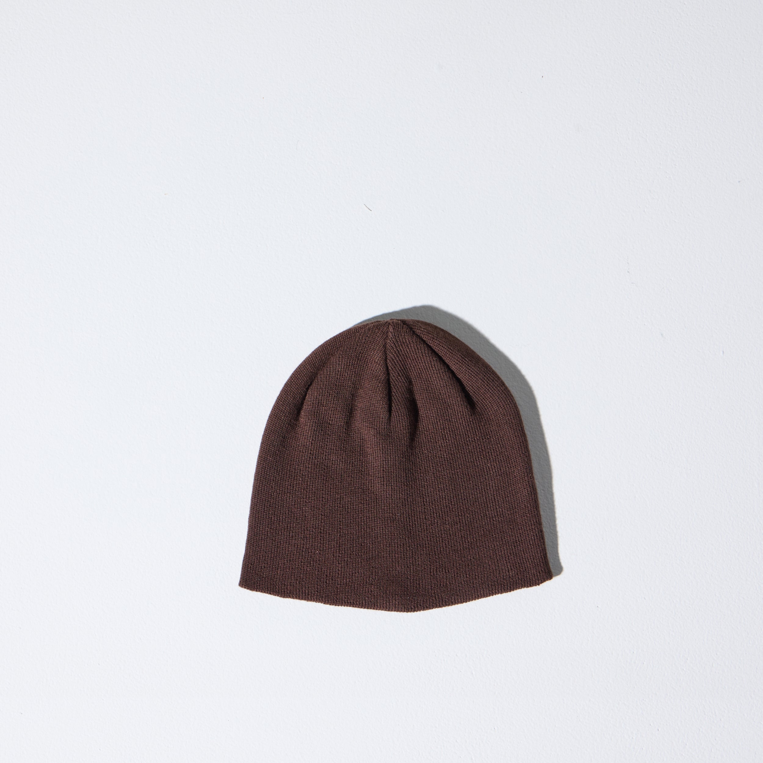 A cacao brown Skully Beanie by House of Peaks on a white background - a 100% Polylana skull cap fit, no cuff, 90’s retro-inspired sustainable knit hat.