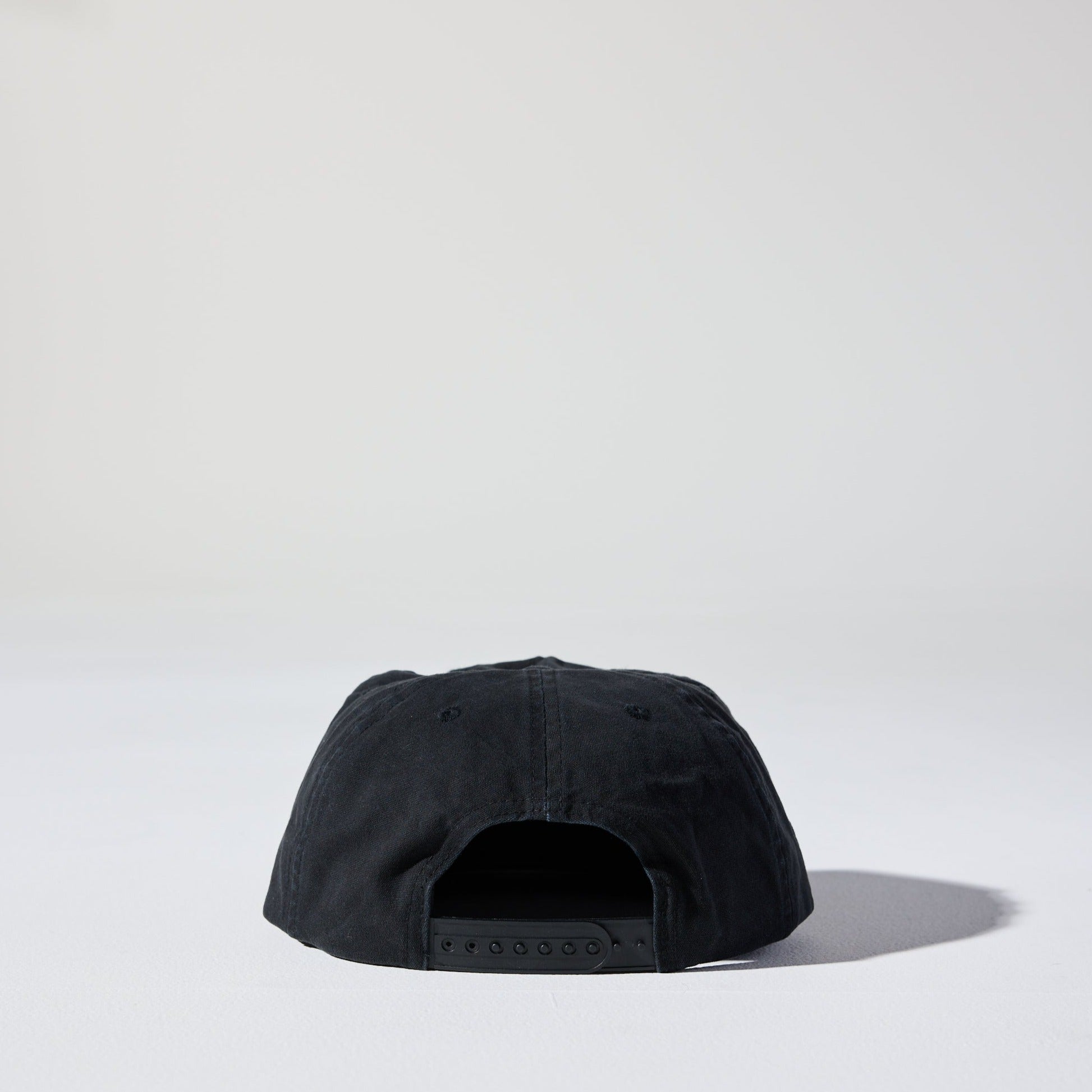 The Tomorrow Cap by House of Peaks is an ebony black 5 panel structured cap with a flat peak and an adjustable snap closure. Perfect for larger heads.
