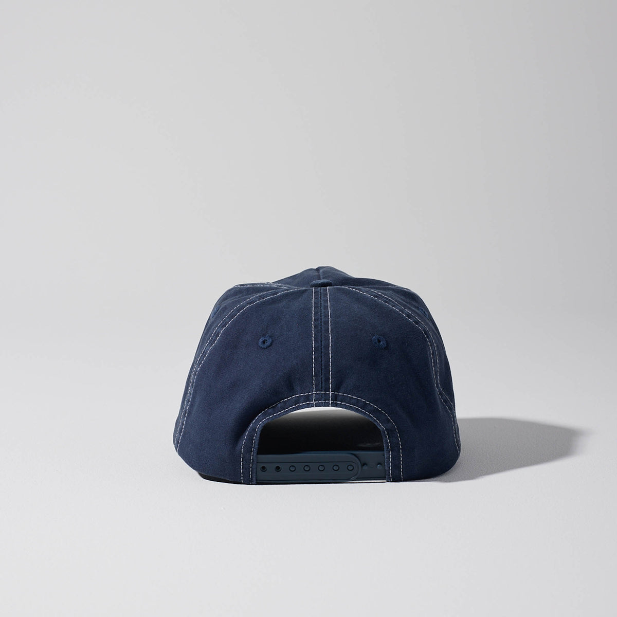 Short Peak Full Curve 5 panel cap. Structured Curved Peak. Vintage Navy with contrast white stitching. Baseball cap. Australian hats. Snapback