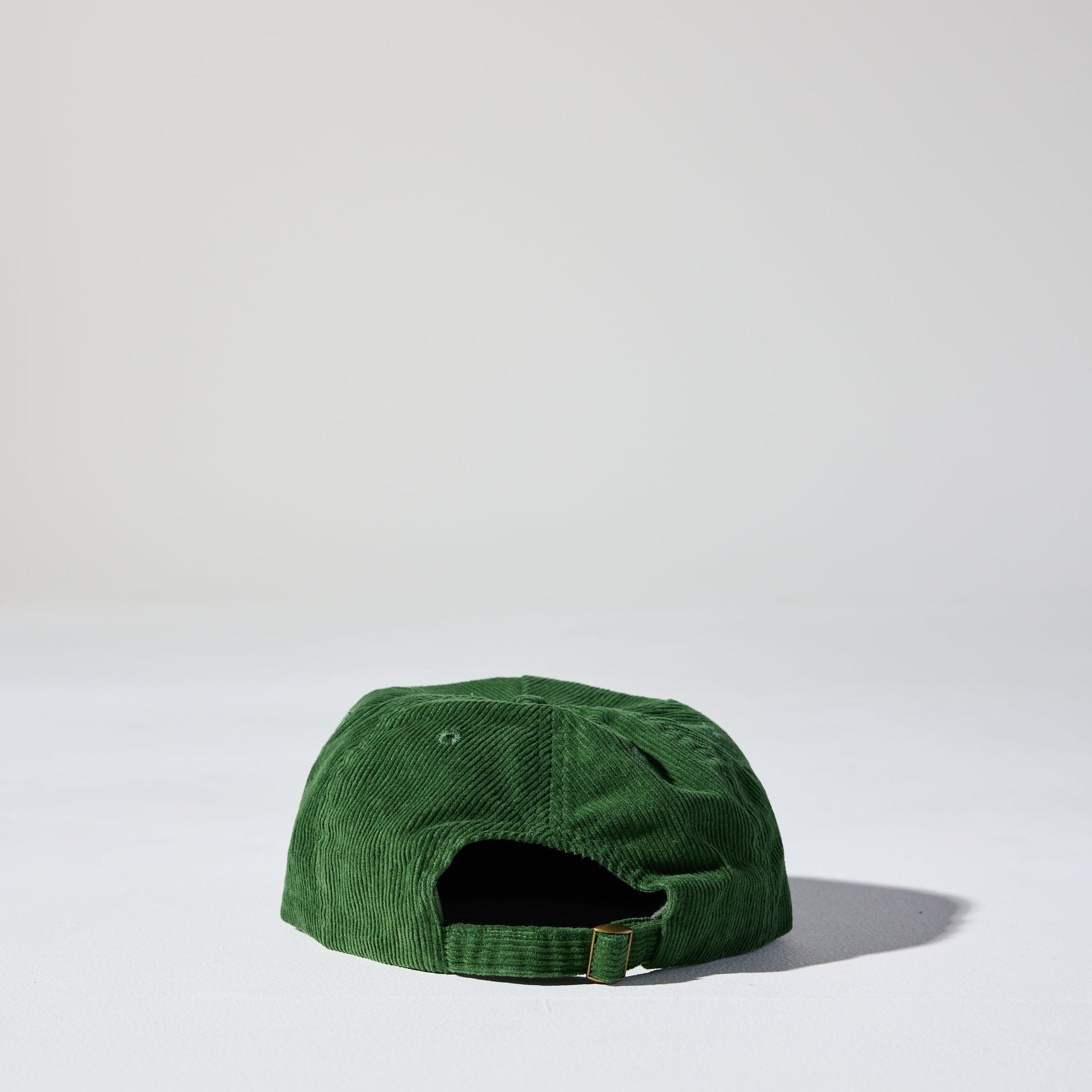 A forest green corduroy unstructured 5 panel cap with an adjustable buckle fastener by House of Peaks, Best blank hats in Australia.