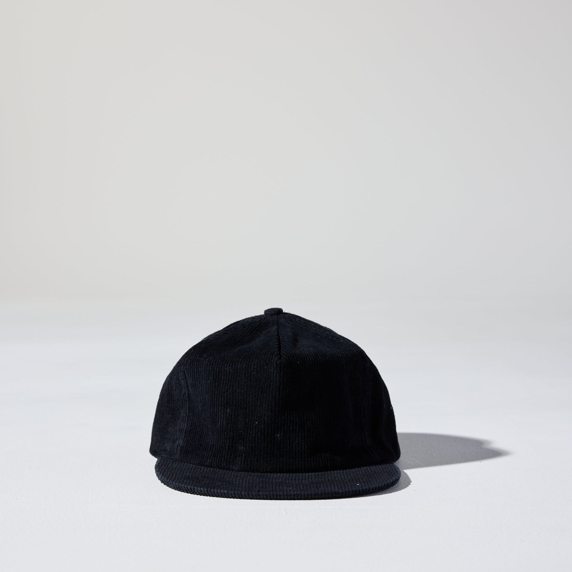 A black corduroy unstructured 5 panel cap with an adjustable fastener by House of Peaks, Best blank hats in Australia.