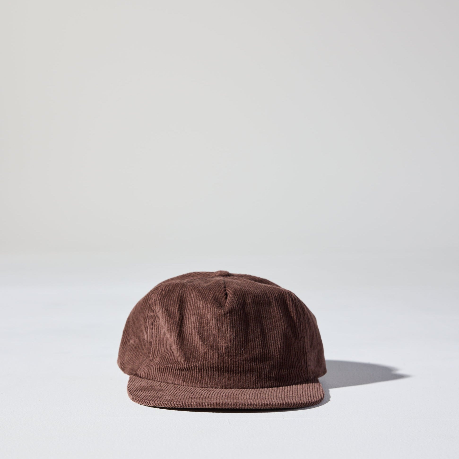 A chocolate brown corduroy unstructured 5 panel cap with an adjustable fastener by House of Peaks, Best blank hats in Australia.