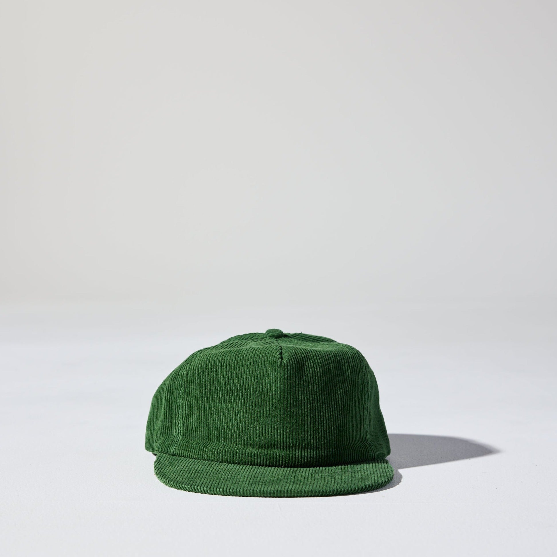 A forest green corduroy unstructured 5 panel cap with an adjustable fastener by House of Peaks, Best blank hats in Australia.